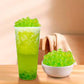 Green apple popping boba added into a tea drink