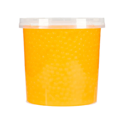 Passionfruit popping boba added into a milk tea drink