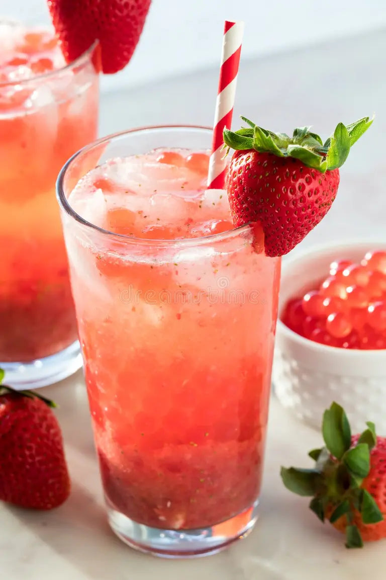 Strawberry popping boba added into a fruit tea drink